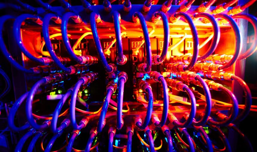 Supercomputer with row of cables in neon light